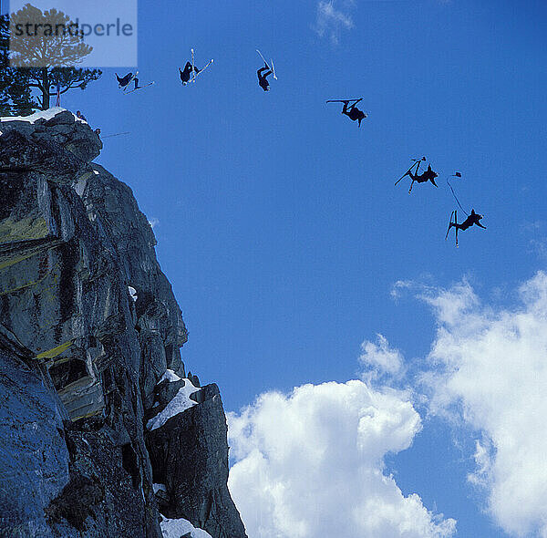 Eric Roner pulling a back flip while ski-BASE jumping at Lover's Leap  near Lake Tahoe. Ski-BASEing is a hybrid of extreme skiing and BASE jumping in which one skis of a steep cliff with a parachute.