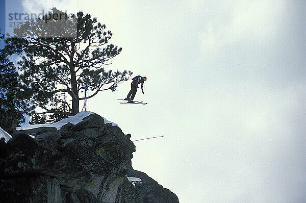 Miles Daisher pulling a front flip while ski-BASE jumping at Lover's Leap  near Lake Tahoe. Ski-BASEing is a hybrid of extreme skiing and BASE jumping in which one skis of a steep cliff with a parachute. There is little room for error.