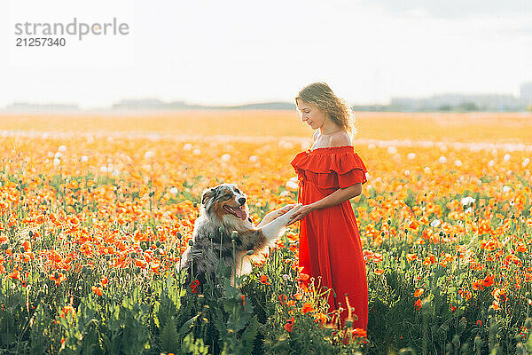 woman and her dog are seen joyfully frolicking together