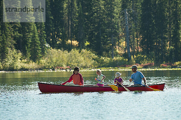 A family paddles a canoe in Grand Teton National Park  Jackson Hole  Wyoming.