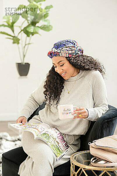 Woman relaxing and looking at a magazine