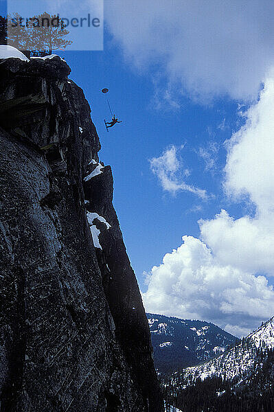 Ski-BASE jumping at Lover's Leap  near Lake Tahoe  California. Ski-BASEing is a hybrid of extreme skiing and BASE jumping in which one skis of a steep cliff with a parachute. There is little room for error.