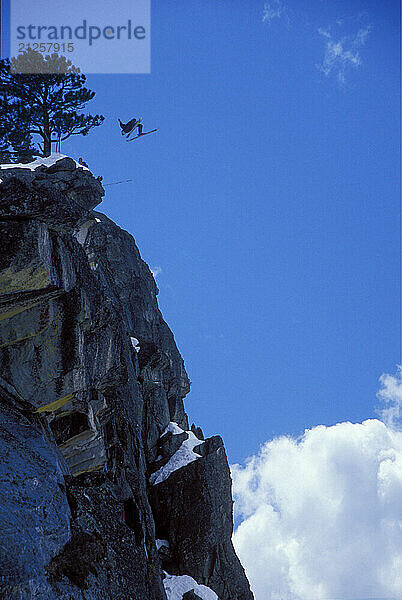 Eric Roner pulling a back flip while ski-BASE jumping at Lover's Leap  near Lake Tahoe. Ski-BASEing is a hybrid of extreme skiing and BASE jumping in which one skis of a steep cliff with a parachute. There is little room for error.