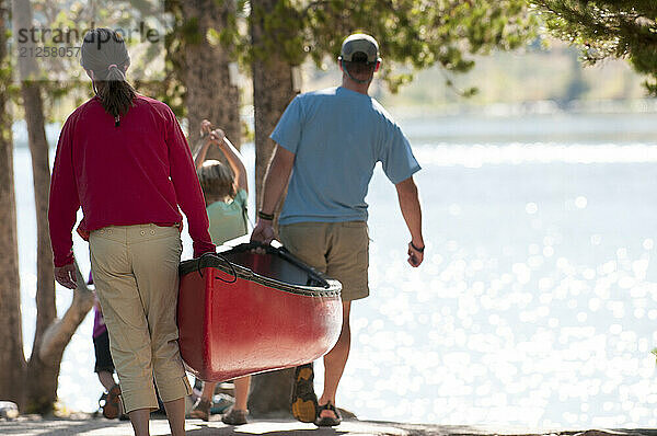 A family carries a canoe in Grand Teton National Park  Jackson Hole  Wyoming.