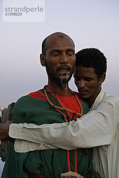 One of the dervishes calming down  coming back to consciousness from a deep trance after Zikr ritual in Omdurman  Sudan.