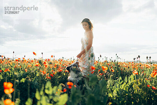 woman and her energetic australian shepherd dog