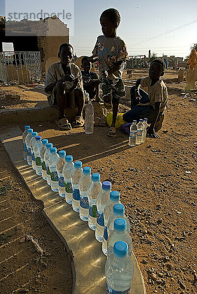 Children selling water during Zikr near Sheikh Hamed al-Nil tomb in Omdurman  Sudan.