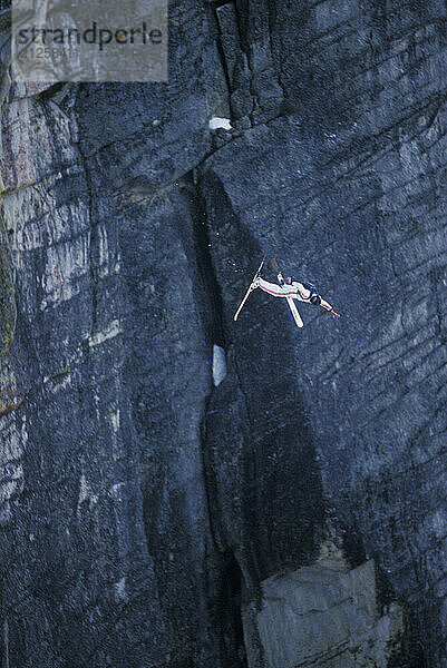 Jesse Hall doing a front flip while ski-BASE jumping at Lover's Leap  near Lake Tahoe. Ski-BASEing is a hybrid of extreme skiing and BASE jumping in which one skis off a steep cliff with a parachute.