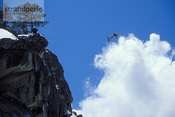 Mark Ridley pulling a back flip while Snowboard-BASE jumping at Lover's Leap  near Lake Tahoe. Board-BASEing is a hybrid of extreme snowboarding and BASE jumping in which one rides off a steep cliff with a parachute.