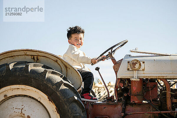 Little boy on a tractor having fun