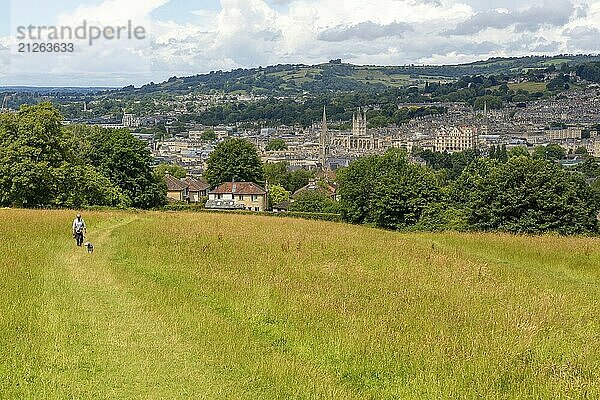 Blick über das Stadtzentrum von Bath von Smallcombe  Widecombe  Bath  Somerset  England  UK mit Frau  die mit ihrem Hund spazieren geht