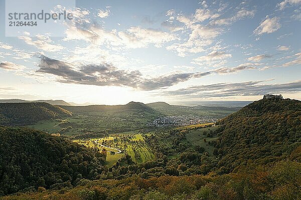 Herbstliche Stimmung auf der Schwäbischen Alb mit Burgruine Burgfestung Hohen Neuffen zum Sonnenuntergang. Blick ins Tal und Richtung Neuffen  welches von tiefstehender Sonne angestrahlt wird