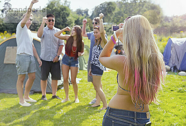 Back View of Woman Taking a Photograph of Group of Teenagers