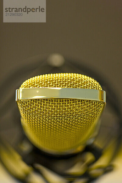 Extreme close up of a gold microphone