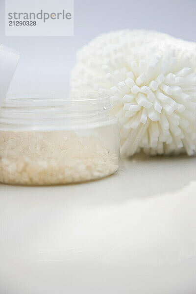 Close up of a jar of bath salts and sponge