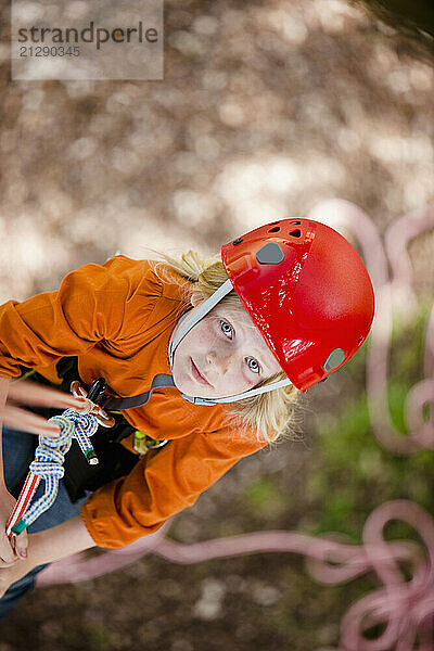 Young girl dangling from a rope - high angle