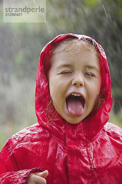 Young Girl with Tongue Sticking Out in the Rain