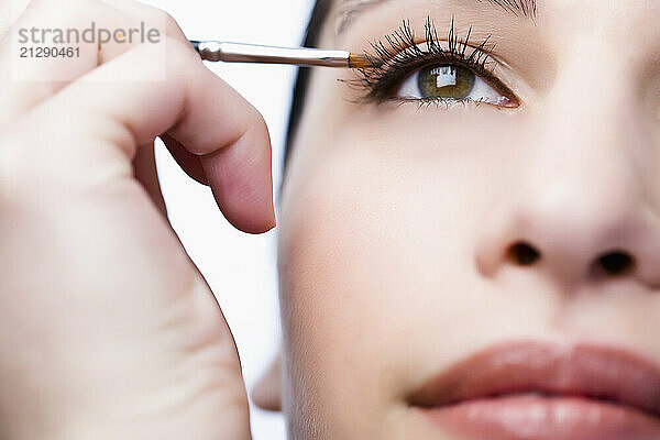 Extreme close up of a woman applying eyeshadow