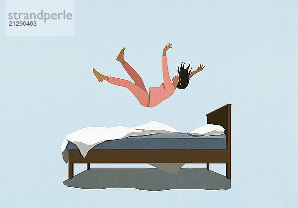 Woman in pajamas falling onto bed