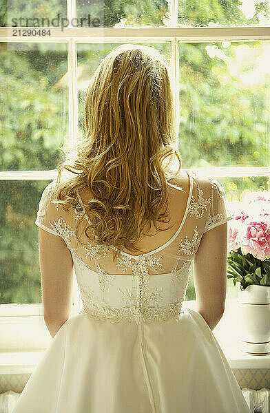 Back View of Young Bride Looking Out of Window