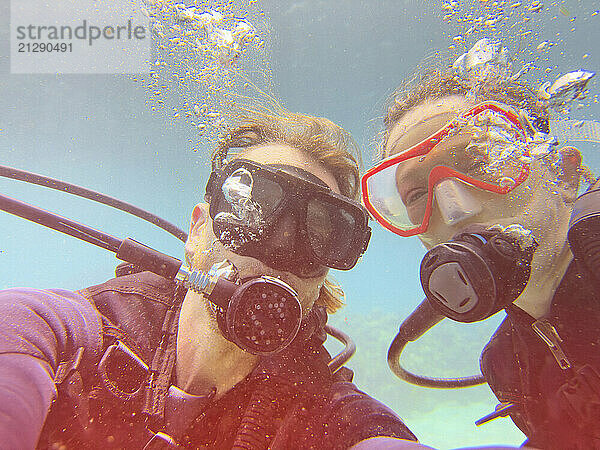 Portrait happy couple scuba diving underwater in sea  Kingstown  Saint Vincent and the Grenadines