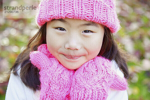 Close up Portrait of Young Girl Wearing Pink Hat and Gloves