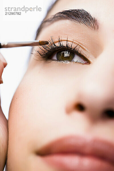 Extreme close up of a woman applying eyeshadow