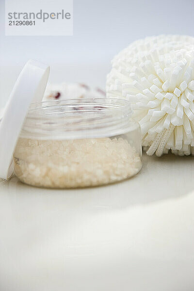 Close up of a jar of bath salts and sponge