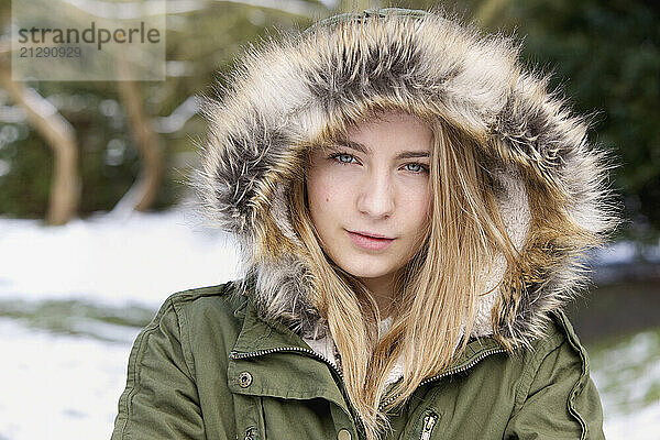 Teenage Girl Wearing Hooded Parka Outdoors