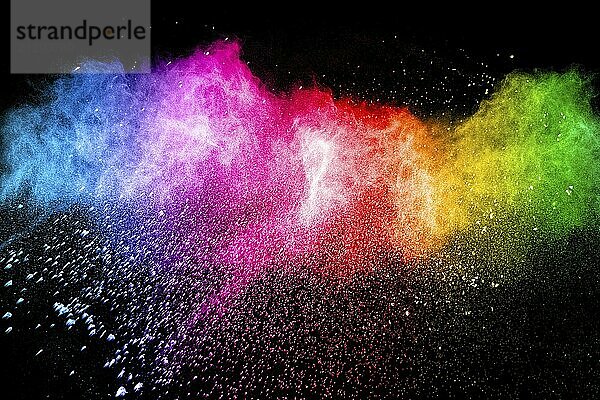 Multicolored powder explosion on black background. Color dust splash cloud on background. Launched colorful particles on background