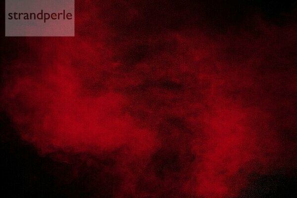 Red powder explosion cloud on black background