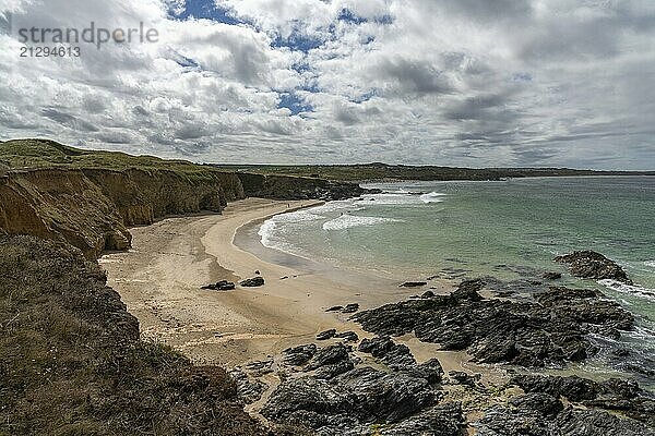 A view of the beautiful golden sand beach at Gwithian with tropical turquoise ocean water and a view of the Cornwall Coast