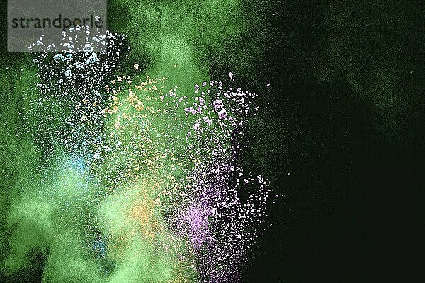 Multicolored powder explosion on white background. Color dust particle splashing