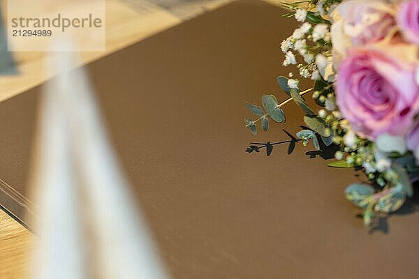 Close-up of a menu on a festively laid table with a bouquet of flowers