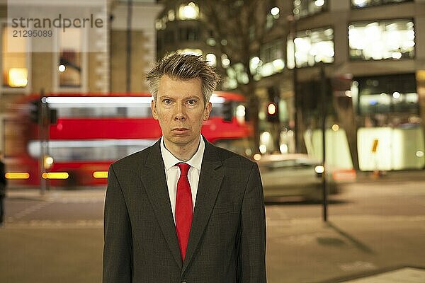 Businessman standing still at night