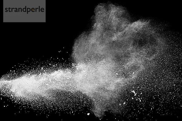 Bizarre forms of white powder explosion cloud against black background.White dust particles splash