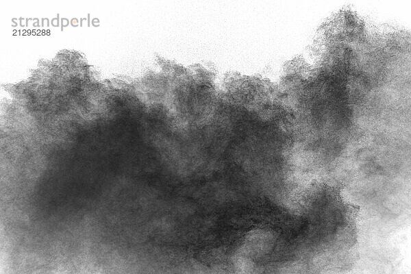 Black powder explosion against white background.Charcoal dust particles cloud