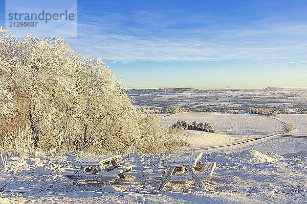 Rest area with benches and tables at a beautiful view on a hill in a frosty and snowy winter in the countryside  Ålleberg  Falköping  Sweden  Europe