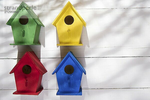 Small colorful houses for shelter birds hung on a wall