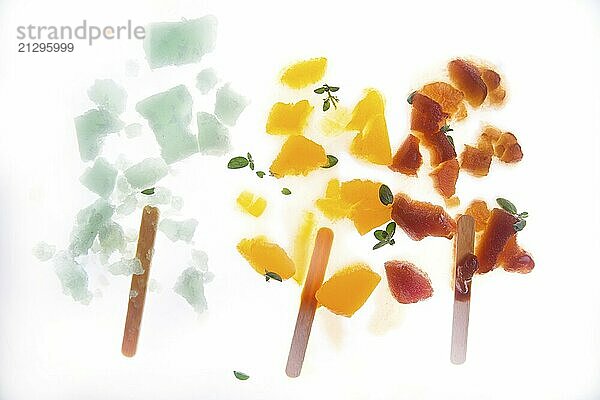 Fruit ice cream of different colors on white background crushed