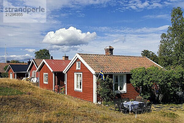 Traditional red painted houses in the Swedish village Holick on the Hornslandet peninsula at the Bothnian Gulf