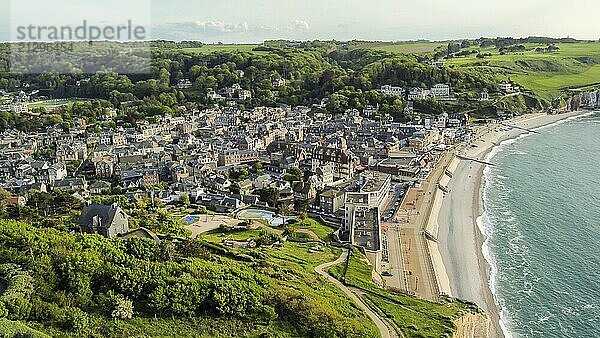 Aerial view on Etretat village in Normandy and beach and water of Manche (English channel) . Beautiful placce for summer activities:walking  swimming. There amazing cliffs include Falaise d'Avaln