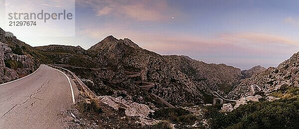 Panorama sunrise landscape in the Tramuntana mountains of Mallorca with a view of the landmark snake road leading down to Sa Calobra