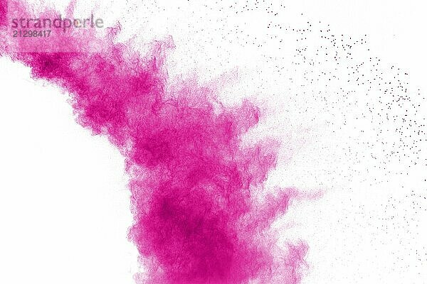 Abstract pink powder explosion on white background. Freeze motion of pink dust splattered