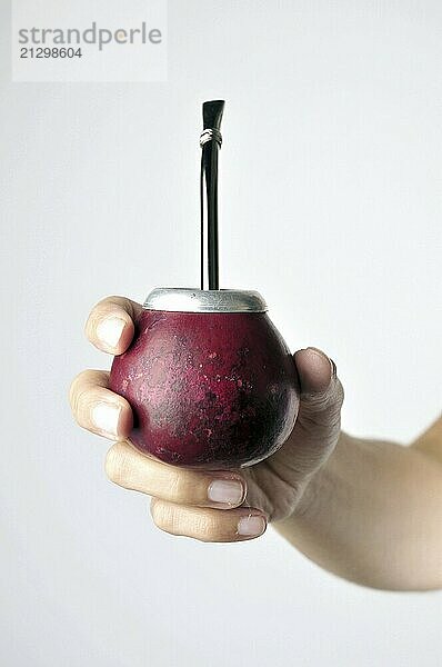 Hand and Yerba Mate drink on white background