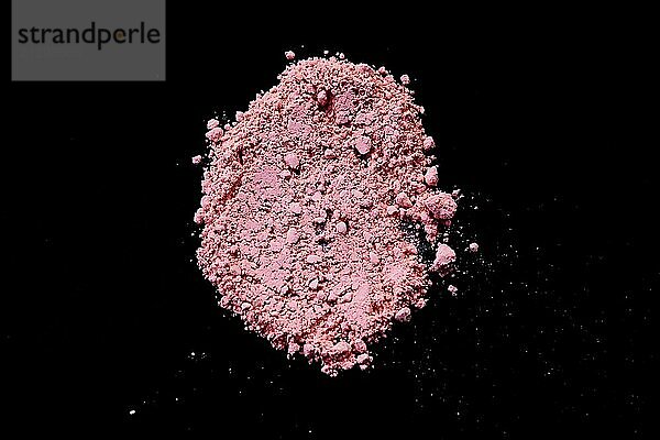 Pink color background of chalk powder. Pink color dust particles splattered on black background