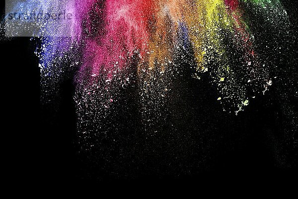 Abstract multi color powder explosion on black background. Freeze motion of colorful dust particles splash. Painted Holi