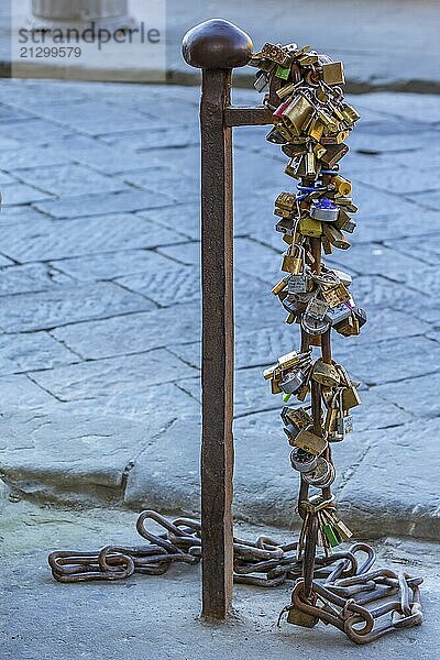 Padlocks on a pole in the street