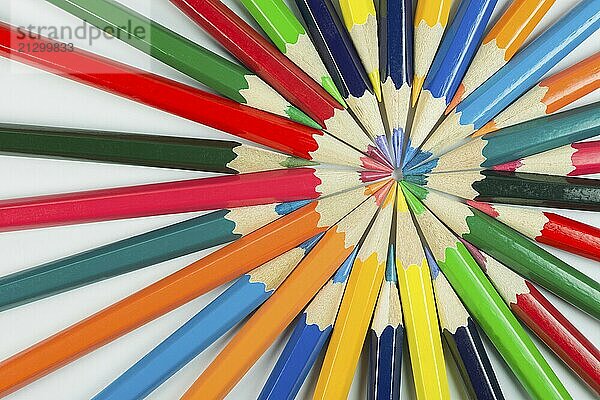 Abstract composition of complementary cirkel with color pencils against a white background