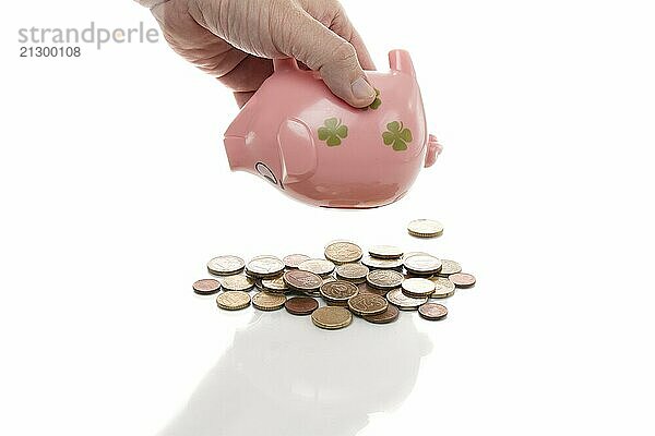 Pink piggy bank with euros on a white background